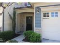 Charming home entrance with stone accents, manicured bushes, and covered entryway at 802 Brier Crossing Loop, Durham, NC 27703
