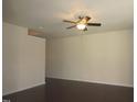 Spacious living room featuring dark hardwood floors, a ceiling fan, and natural light at 802 Brier Crossing Loop, Durham, NC 27703