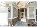 Close-up of the home's front entrance featuring stone accents and classic architectural details at 803 Footbridge Pl, Cary, NC 27519