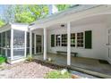Home's covered porch showing seating, green shutters, and easy access to the screened porch at 803 Old Mill Rd, Chapel Hill, NC 27514