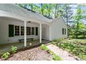 Home's inviting entrance with brick pathway, covered porch, and well-maintained landscaping at 803 Old Mill Rd, Chapel Hill, NC 27514