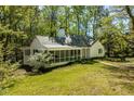Charming home with a screened porch, lush greenery, and inviting curb appeal at 803 Old Mill Rd, Chapel Hill, NC 27514
