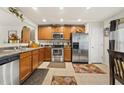 Functional kitchen featuring stainless steel appliances, wood cabinets, and a tile floor at 8520 Quarton Dr, Raleigh, NC 27616
