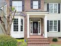 Welcoming front entrance with brick steps, white columns, and a decorative door with sidelights at 113 Chesterfield Dr, Cary, NC 27513