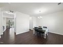 Bright dining room featuring dark wood flooring and a stylish light fixture at 115 Zulabelle Ct, Garner, NC 27529