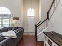 Grand foyer with high ceilings, hardwood floors, and a staircase bathed in natural light at 117 Whitehaven Ln, Cary, NC 27519