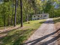 Home with driveway and ample yard space and mature trees at 120 King Charles Rd, Hillsborough, NC 27278