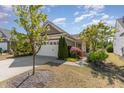 Charming single-story home featuring a manicured lawn and an attached two-car garage at 1206 Areca Way, Durham, NC 27703