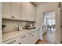 Well-appointed butler's pantry with white cabinetry, quartz countertops, and stylish backsplash at 125 Verona Villa Dr, Burlington, NC 27215