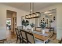 Open-concept dining area with a large table, elegant chairs, stylish lighting, and beautiful decor at 125 Verona Villa Dr, Burlington, NC 27215