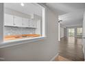 The kitchen features a breakfast bar, white cabinets, butcher block counters, a tile backsplash, and wood-look flooring at 128 Schultz St, Chapel Hill, NC 27514
