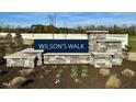 Welcome to Wilson's Walk, as shown by the community's elegant stone sign at 129 N Keatts Winner Ct, Wilson's Mills, NC 27520