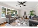 Bright living room with large window, neutral color scheme, ceiling fan, and modern furniture at 1701 Pinedale Dr, Raleigh, NC 27603