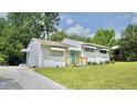 Beautiful home featuring well-kept lawn, driveway, and a vibrant, eye-catching blue front door at 2006 Waters Dr, Raleigh, NC 27610