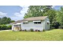 An alternate exterior angle, revealing a well-maintained lawn and a quaint deck area at 2006 Waters Dr, Raleigh, NC 27610