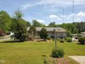 The home boasts a spacious backyard with a deck, gazebo, and mature trees, perfect for outdoor enjoyment at 206 Lane Of Tristram, Garner, NC 27529