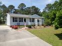 Neat single-story home featuring vinyl siding, dark shutters, and a well-maintained lawn with landscaping at 206 Lane Of Tristram, Garner, NC 27529
