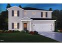 Charming two-story home with a well-manicured lawn, covered entryway, and attached two car garage at 2227 Cherry Creek Rd, Haw River, NC 27258