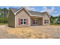 Charming single-story home with tan siding, red shutters, and a well-manicured lawn at 2820 Tara Dr, Clayton, NC 27520