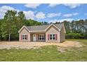Charming single-story home with tan siding, red shutters, and a well-manicured lawn at 2820 Tara Dr, Clayton, NC 27520