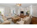 Spacious living room with hardwood floors, decorative columns, and an abundance of natural light at 30038 Village Park Dr, Chapel Hill, NC 27517