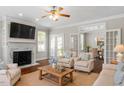 Cozy living room featuring a fireplace, hardwood floors, and French doors leading to dining area at 30038 Village Park Dr, Chapel Hill, NC 27517