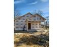 New construction home with exposed wood frame and protective sheathing against a blue sky at 307 Burke St, Dunn, NC 28334