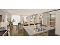 Open concept kitchen with stone countertops, stainless steel appliances, and lots of natural light at 307 Burke St, Dunn, NC 28334