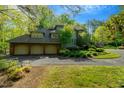 Spacious brick home featuring a three-car garage and a circular driveway at 3203 Cameron Dr, Henderson, NC 27536