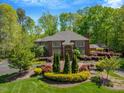 Stately brick home with mature trees, manicured lawn, and colorful landscaping at 3203 Cameron Dr, Henderson, NC 27536