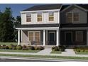Charming two-story home with an inviting entryway, front porch, and landscaped yard at 3701 Rosebush Dr, Zebulon, NC 27597