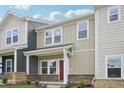 Attractive townhome with neutral siding, a covered porch, and well-manicured landscaping at 3705 Rosebush Dr, Zebulon, NC 27597