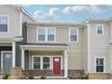 Inviting two-story townhome boasts a covered porch and classic architectural details at 3705 Rosebush Dr, Zebulon, NC 27597