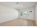 Bright living room with wood-look floors and natural light streaming through the windows at 3705 Rosebush Dr, Zebulon, NC 27597