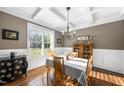Elegant dining room with hardwood floors, coffered ceilings, and a vintage china cabinet at 3805 Watermark Dr, Franklinton, NC 27525