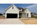 Charming new two-story home with a two-car garage, board and batten siding, and a welcoming front porch at 3820 Fairway View Dr # 16, Fuquay Varina, NC 27526