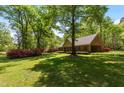 Well-maintained home surrounded by lush greenery and vibrant azaleas at 4298 Old Stage S Rd, Erwin, NC 28339