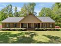 Inviting single-story brick home with a symmetrical design and manicured landscaping at 4298 Old Stage S Rd, Erwin, NC 28339