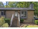 Charming brick home featuring a welcoming entrance with well-maintained landscaping at 500 W Woodcroft Pkwy # 13D, Durham, NC 27713