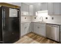 Well-lit kitchen featuring updated cabinets, granite countertops, and stainless steel appliances at 500 W Woodcroft Pkwy # 17C, Durham, NC 27713