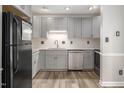 Updated kitchen featuring gray cabinets, granite countertops, and stainless steel appliances at 500 W Woodcroft Pkwy # 17C, Durham, NC 27713