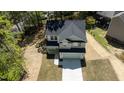 Aerial view of a modern two-story home with a two-car garage, located in a peaceful, wooded community at 5022 Mockingbird Ln, Sanford, NC 27332