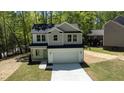 Charming two-story home with a two-car garage, featuring a modern color scheme and well-manicured lawn at 5022 Mockingbird Ln, Sanford, NC 27332