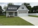 Attractive two-story home with gray siding, a two-car garage, and a lush green lawn in a suburban setting at 520 S Lincoln St, Benson, NC 27504