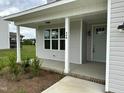 Welcoming front porch features classic columns, a stylish front door, and manicured landscaping at 520 S Lincoln St, Benson, NC 27504