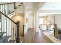 Inviting entryway with hardwood floors, staircase and a glimpse into a cozy living space at 5265 Aleppo Ln, Raleigh, NC 27613