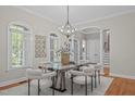 Elegant dining room with a marble table, stylish chairs, and ample natural light at 5504 Spring Bluffs Ln, Raleigh, NC 27606