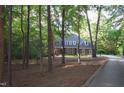 Secluded brick home nestled among mature trees, offering privacy and a natural setting at 5504 Spring Bluffs Ln, Raleigh, NC 27606