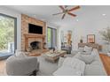 Bright living room with a stone fireplace, modern furniture, and sliding glass doors at 5504 Spring Bluffs Ln, Raleigh, NC 27606