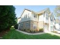 Two-story home boasts a stone facade, lush lawn, and well-maintained landscaping at 5901 Chivalry Ct, Raleigh, NC 27612